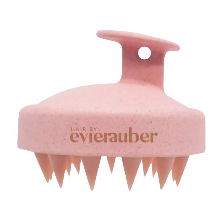 Pink scalp brush with 'Hair by evierauber' branding on a white background